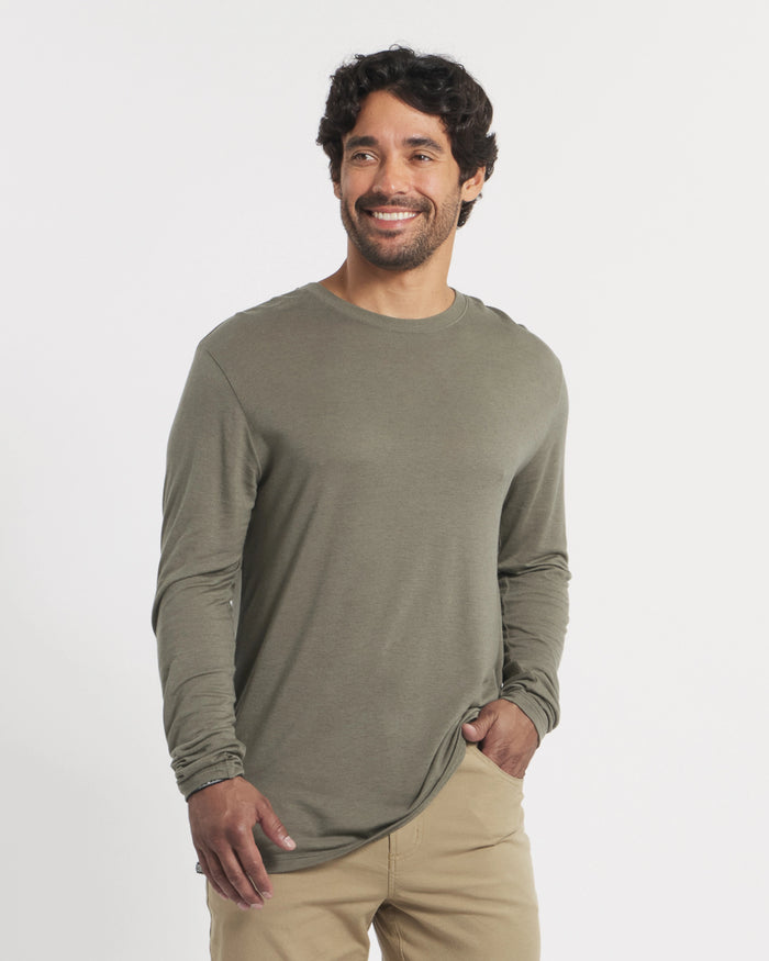 Man wearing a green long-sleeve shirt against a white background