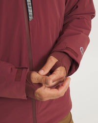 Close-Up of Hands Through Thumbholes of Burgundy Men’s Apu Parka Sustainable Ski Jacket – PAKA Apparel