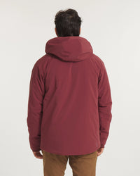 Back view of Men’s Apu Parka in burgundy on a model, showing insulated hood and hip-length shell on a plain light background