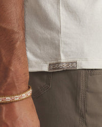 Side Waist View of Peruvian Inca Tag on Essential Tee Men's Pima Cotton and Alpaca T-Shirt in Bone / Off White – PAKA Apparel