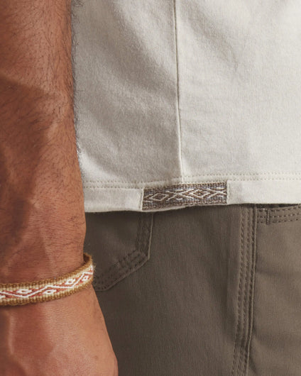 Side Waist View of Peruvian Inca Tag on Essential Tee Men's Pima Cotton and Alpaca T-Shirt in Bone / Off White – PAKA Apparel