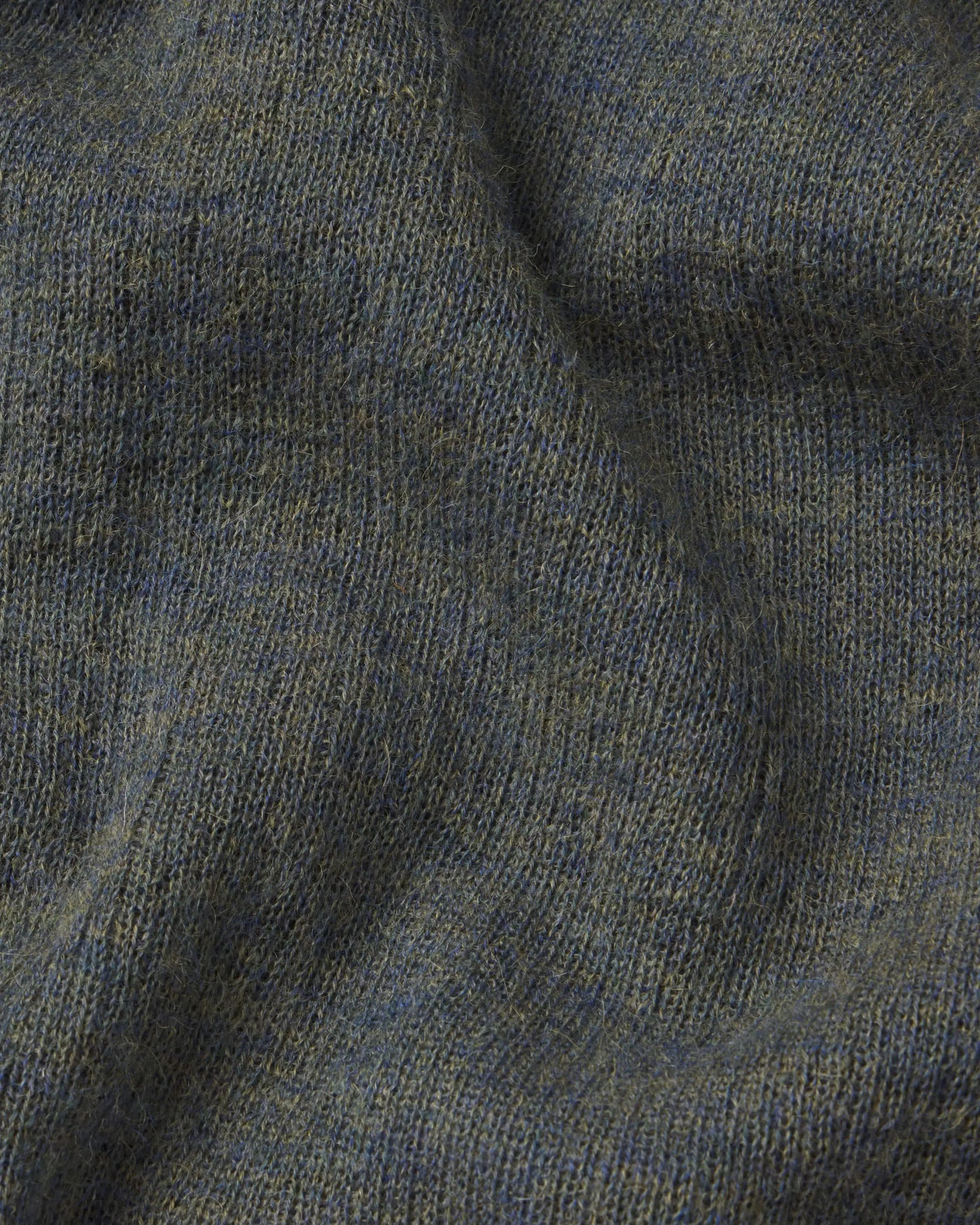 Close-up of textured green fabric with a focus on pattern and color.