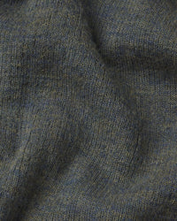 Close-up of textured green fabric with a focus on pattern and color.