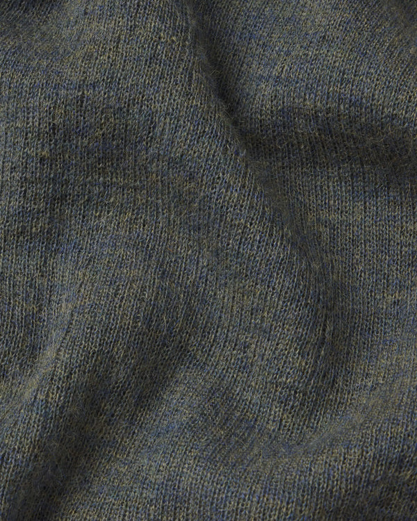 Close-up of textured green fabric with a focus on pattern and color.