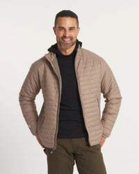 Model Smiling with Hands on Waist in Sustainable Men's Mayu Ultralight Jacket in Fossil / Tan – PAKA Apparel
