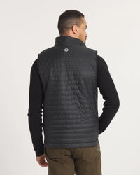 Back view of Men’s Mayu Ultralight Vest showing quilted packable alpaca insulated puffer with stand collar on a light studio background