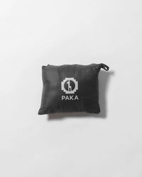 Top view of Men’s Mayu Ultralight Vest packed in black PAKA pouch showing compact packability on light background