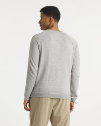 Back view of Men’s Ultralight 1.0 Crew alpaca sweater showing raglan sleeve seams and ribbed hem on white background