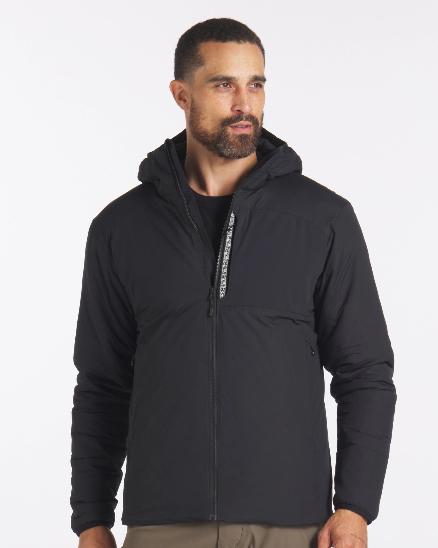 Male Model Wearing Apu Men’s Black Sustainable Lightweight Puffer Jacket with PAKAFILL® Alpaca Natural Fiber Insulation – PAKA Apparel