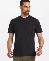 Model is 6'3" and wearing size Large. Man Wearing Sustainable Black T-Shirt in Organic Pima Cotton and Alpaca Blend – PAKA Apparel