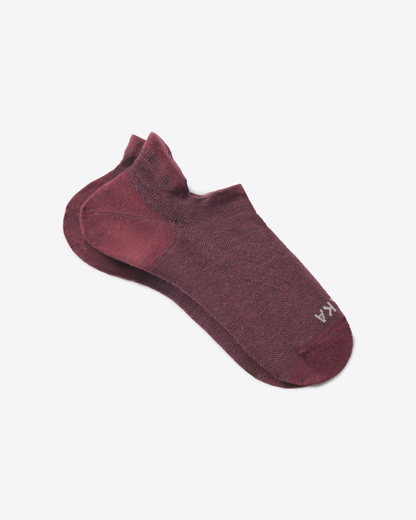 Top-down view of Trail Ankle Socks showcasing low-cut ankle height and heathered raisin color on a light background