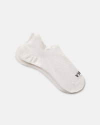 Angled view of white Trail Ankle Socks showing low-cut height, knit pattern, and cushioned sole on light gray background