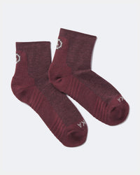 Angled view of Trail 1/4 Crew socks in maroon showing ankle-length fit and cushioned arch and toe on light gray background