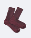 Flat lay of Trail 3/4 Crew Socks in burgundy showing ribbed arch, cushioned sole, and PAKA logo on toe