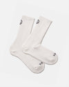 Top-down view of white Trail Crew socks showing mid-calf height, ribbed cuff and reinforced heel and toe on a light gray background