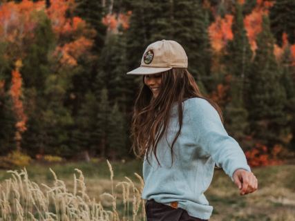A girl wearing our Sky Blue Crewneck sweater outdoors