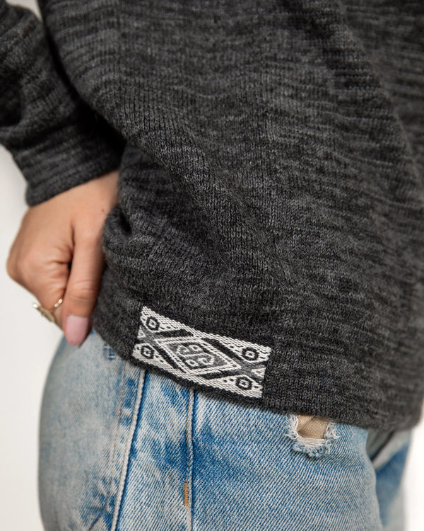 Closeup Side Shot of Charcoal / Grey Peruvian Alpaca Wool Sweater on Woman Wearing Ring – PAKA The Original Crew