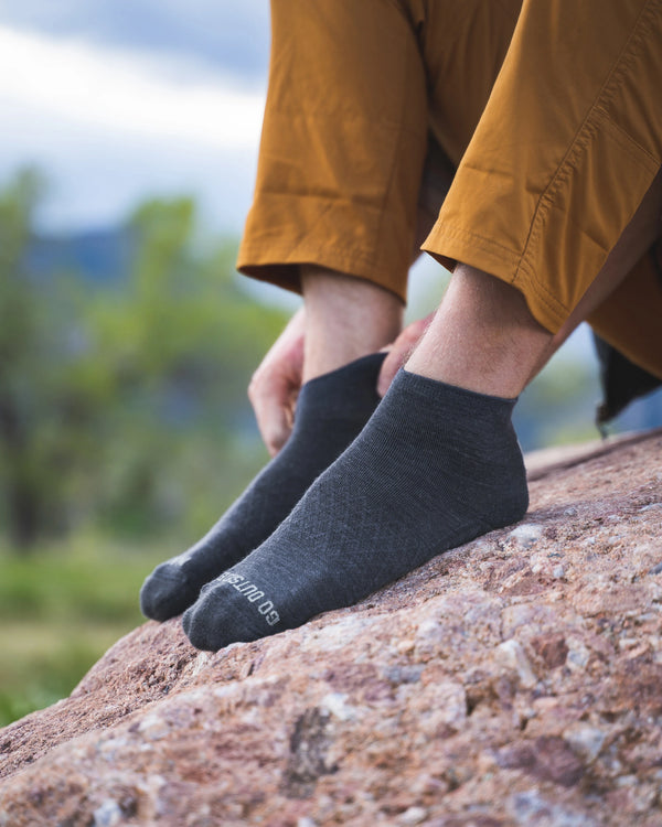 Man putting on 1/4 crew socks