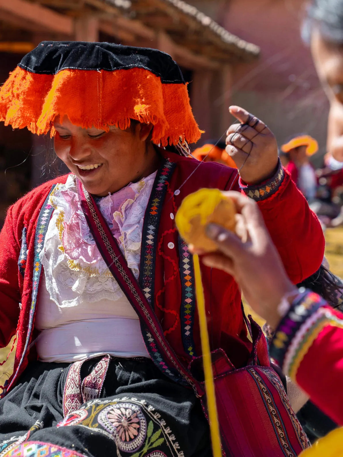 A quechua woman smiling in her traditional costumes