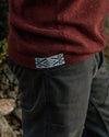 Close-up of PAKA's Burgundy Hoodie with the Inca ID worn by a person outdoors
