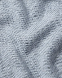 Close-up of The Original Crew alpaca crewneck in sky blue showing soft knit texture and alpaca fiber