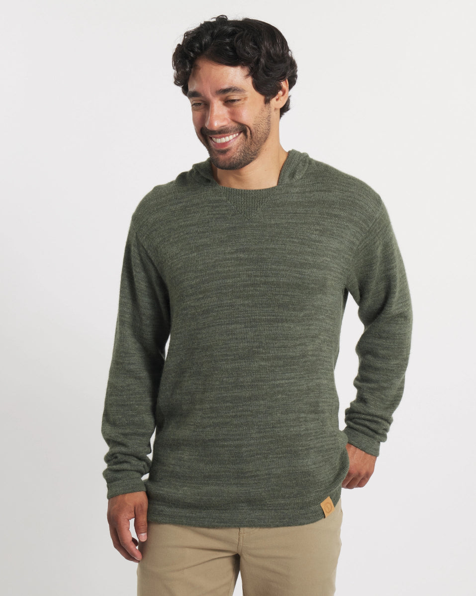 Man wearing a green sweater on a white background