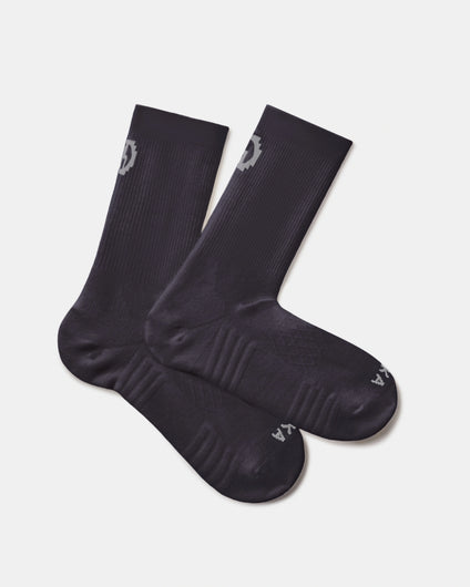 Flat lay of black Trail 3/4 crew socks showing ribbed cuff, arch support, and cushioned footbed on light gray background