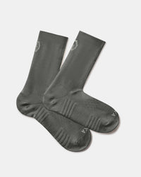 Angled view of Trail 3/4 Crew Socks in black showing ribbed cuff, cushioned footbed, and PAKA logo on a light background