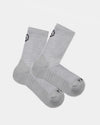 Flat lay of Trail 3/4 crew socks in light gray showcasing cushioned sole and black PAKA logo on cuff and toe on white background