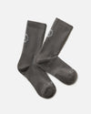 Flat lay of Trail Crew Socks in dark gray showing crew height, cushioned footbed and PAKA logo on white background