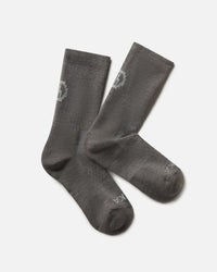 Flat lay of Trail Crew Socks in dark gray showing crew height, cushioned footbed and PAKA logo on white background