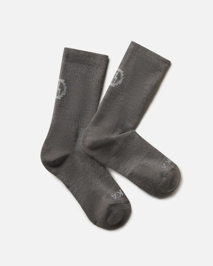 Flat lay of Trail Crew Socks in dark gray showing crew height, cushioned footbed and PAKA logo on white background