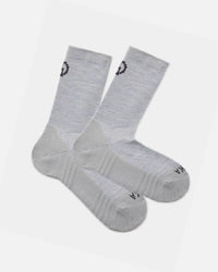 Angled flat lay of Trail Crew socks, light gray alpaca blend with cushioned sole and ribbed crew height on white background