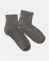 Angled view of Trail quarter crew socks in charcoal with cushioned sole, ribbed arch and ankle cuff on white background