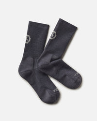 Top-down view of Trail Crew Socks showcasing charcoal blue color, crew height, cushioned footbed and PAKA logo on white background