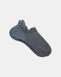 Angled view of Trail Ankle Socks (alpaca) showcasing low-cut ankle fit and reinforced heel in charcoal blue on white background