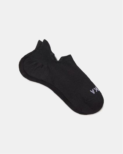 Flat lay of Trail Ankle Socks showcasing low-cut ankle silhouette, cushioned heel, and PAKA logo on white background