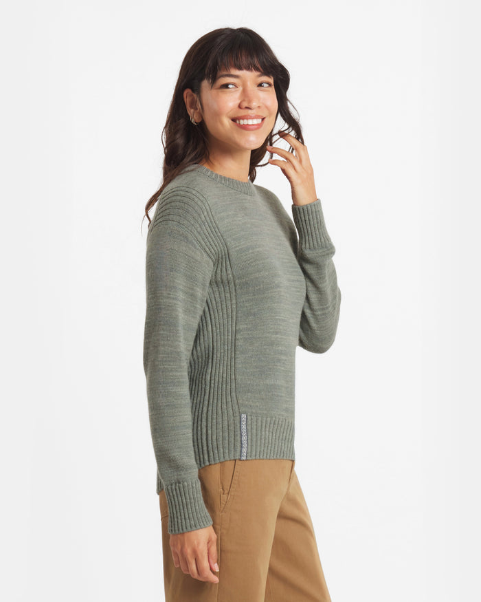 Woman wearing a green sweater on a white background