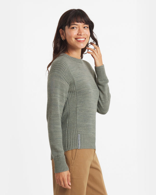 Woman wearing a green sweater on a white background