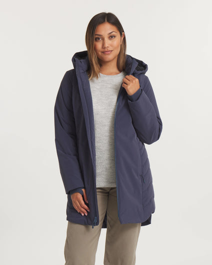 Woman wearing a navy blue coat on a white background