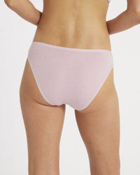 Back view of Women’s Essential Bikini Brief in lilac on model showcasing full-coverage back and soft fabric on white background