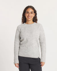 Woman wearing the Women's Mountain Crew Sweater in Light Grey  on a white background