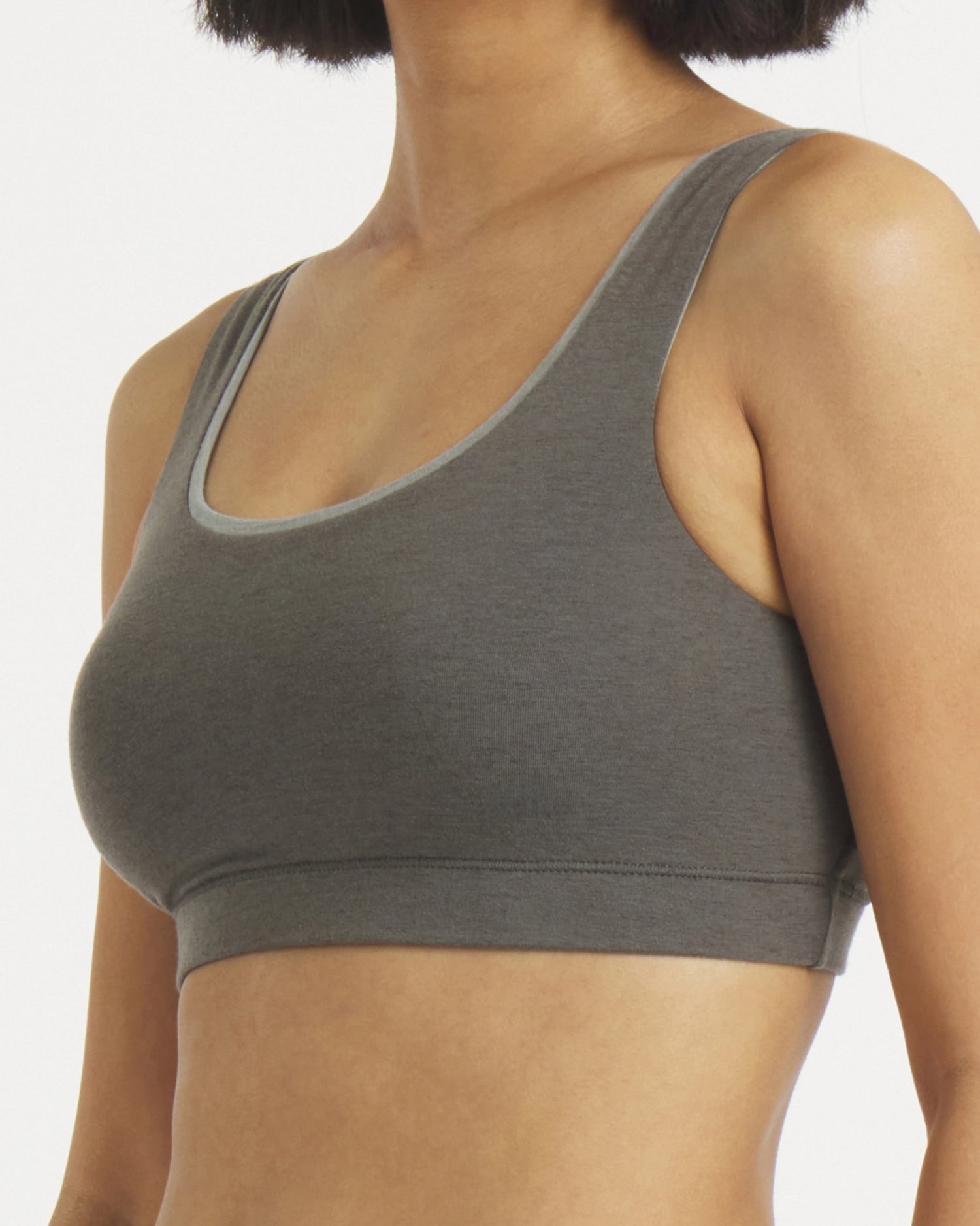 Three-quarter view of Women’s Scoop Bralette in gray on model showing scoop neckline, wide straps, and elastic underband