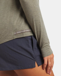 Side close-up of Women’s Sol Crew long sleeve sun shirt in elm showing patterned side hem and slim fit on model