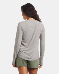 Back view of Women’s Sol Crew long-sleeve alpaca sun shirt in heather grey with raglan sleeves and curved hem on white