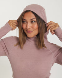 Model Smiling with Hands on Raised Hood of Women's Thermal Hoodie in Magnolia / Pink – PAKA Apparel