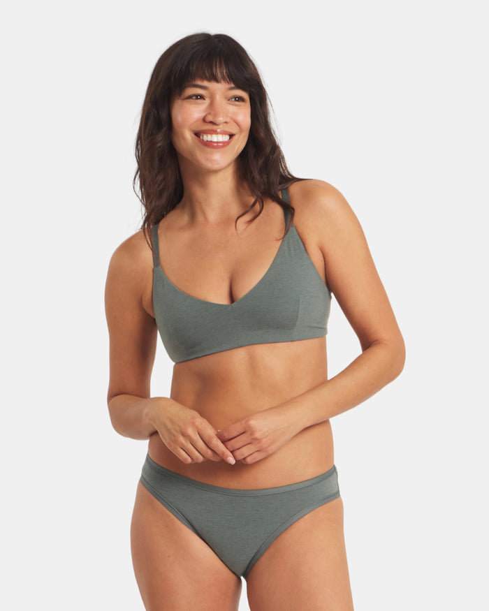 Front view of Women’s Essential Triangle Bralette in Balsam on model showing deep V triangle cups, wireless padless design and embossed Inca-pattern straps