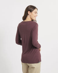 Back view of Women’s Aire long sleeve shirt in fig on model showing slim fit and lightweight drape against white background
