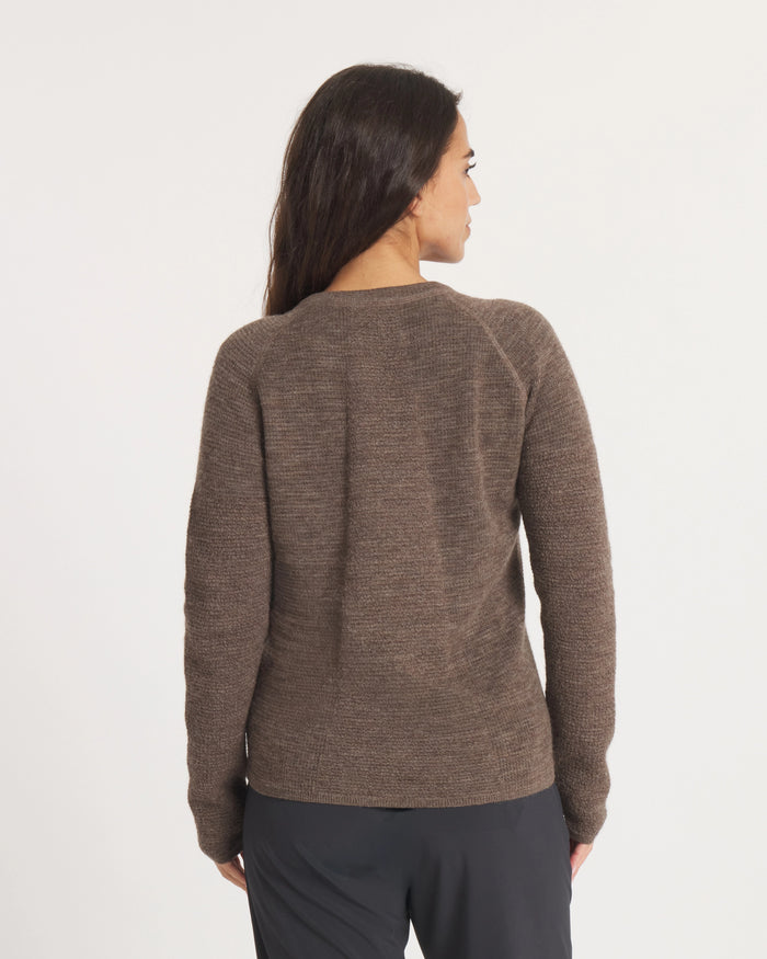 Woman wearing the Women's Mountain Crew sweater in Wood on a white background