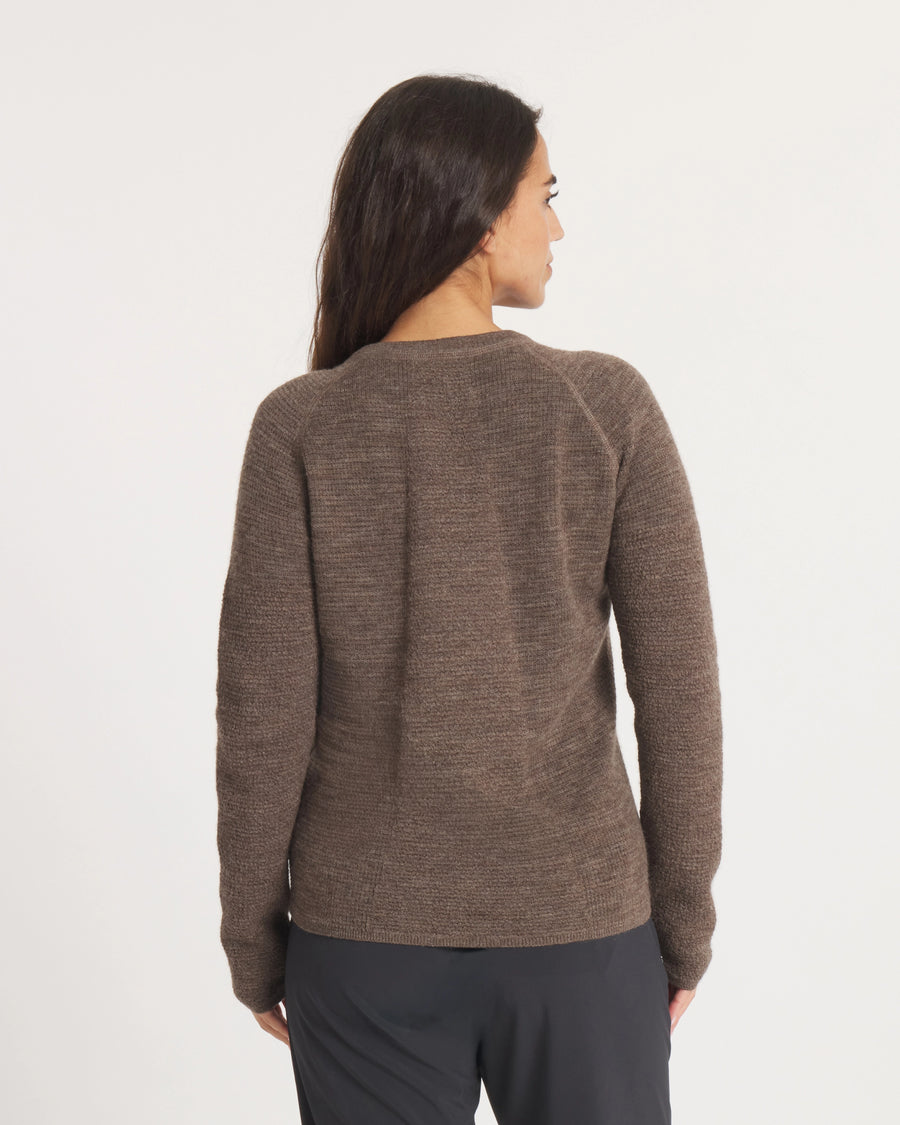 Woman wearing the Women's Mountain Crew sweater in Wood on a white background